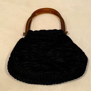 Black hand made purse with tortoise handles. Beautifully crafted details.